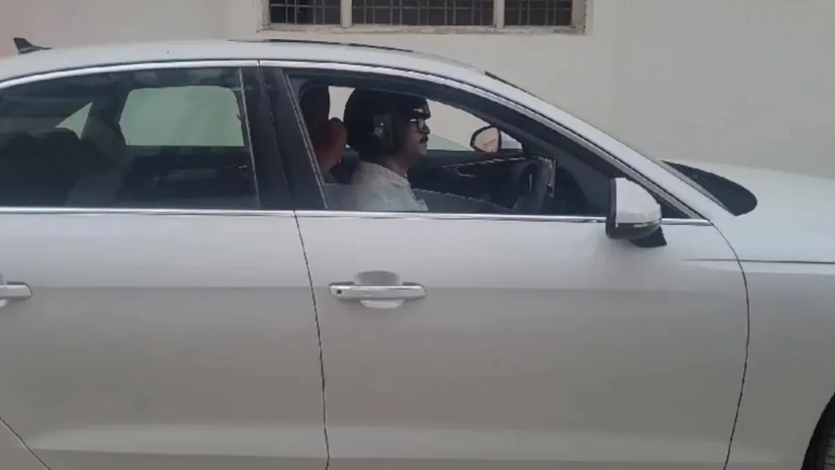 Jhansi wearing helmet while driving car